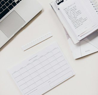 silver laptop computer near notebook