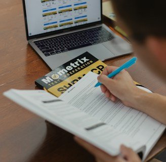 person writing on white paper